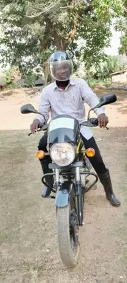 Alex Puhindei uses the motorbike to travel to rural schools